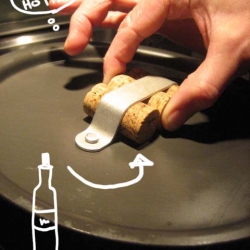 Cork handle! With this solution...you can always pick up the lid even when you don't have cooking mit around.