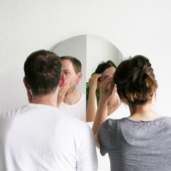 Berlin studio Halb/Halb has created a creased circular mirror that allows two people to see their reflection at the same time.