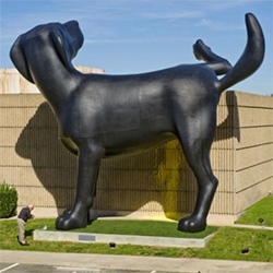 Bad Dog, the 28-foot creation of artist Richard Jackson, is outside of the Newport Museum of Art marking it with yellow paint... 