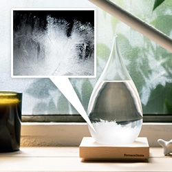 Tempo Drop by Perrocaliente. a modern version of a storm glass, a sealed glass container, filled with distilled water, camphor, and ethanol. And depending on whether it's clear, cloudy, or ice flakes you can tell the weather...