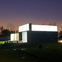 Offices for Ecopellets, an industrial complex located in the outskirts of Santiago de Chile by Iván Bravo. Skinned in zinc plates, it mixes with the industrial landscape.