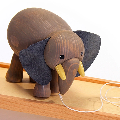 This magical wooden Walking Elephant! Just like some old vintage little plastic toys i have, thanks to a perfectly calibrated weight, it will adorably wobble towards the edge, but never fall off! Hand-made in Germany in the Erzgebirge. See the video!
