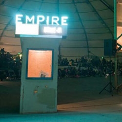 Brooklyn-based artists Jeff Stark and Todd Chandler set up a temporary 'Empire Drive-In' outside the NY Hall of Science, re-purposing junk cars, salvaged wood, and shipping containers. 