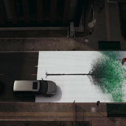 DDB China Group took over a busy pedestrian crossing and placed a large canvas featuring a leafless tree on the road. On either side of the crossing were sponge cushions soaked in green environmentally-friendly washable and quick dry paint. 