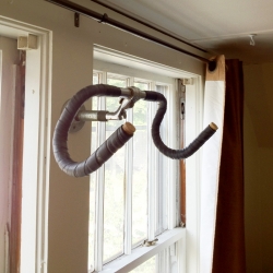 Cool simple DIY hanging bike rack made with a recycled pair of handle bars.