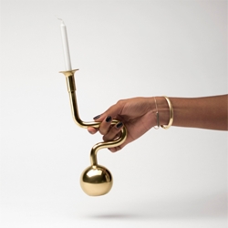 The Horn Candle Holder's playfully bent neck provides a handle for carrying it into the night.