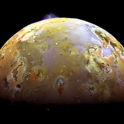 A plume explodes on Jupiter's moon Io.  A reminder that sometimes the greatest of design can be found in the most natural of spontaneity...