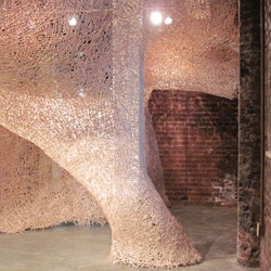Jonathan Brilliant creates full-room, site-specific installations from thousands of coffee stir sticks, as well as, coffee cup sleeves and covers.