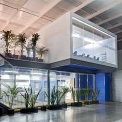 Offices inside an industrial building, freestanding two levels that are easily dismantled with no change to the original building, in Queretaro, Mexico by casaPublica architects.