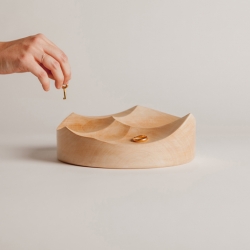 Inspired by the texture left in a yoghurt while eating it with a spoon , The Carved Bowls are a set of solid wood pin trays that combine with different sized concave areas. 