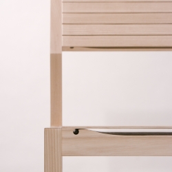 Luukku Chair is designed by Finland-based designer Satoshi Ohtaki. The thin, upper portion of the seat bends toward the lower plank just before its breaking point. This elasticity provides cushioning for an all-wood chair.