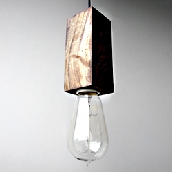 Stunningly simple pendant light made from a solid block of walnut.