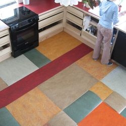 This excellent floor pattern was put together with remnant pieces of linoleum left over from a range of projects. Very cool pattern and smart waste use. Above the parts are laid loose for a test fit.