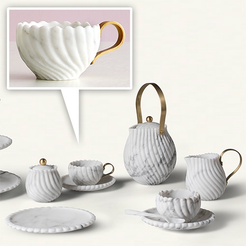 Bethan Gray's Victoria Teaset for Editions Milano. The collection features a relief pattern, hand carved from Arabescato marble by Italian master craftsmen. Hand brushed brass is also used to add warmth.