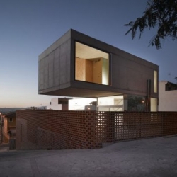 Two atretic houses - balanced one of top of the other - form this single-family home in Spain by Javier Peña Galiano. Surprising from every angle.