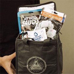 Astronaut Food Picnic Pack - Includes two assorted astronaut ice creams, two space food sticks, and two water pouches, all packed in a thermally lined rations container with Greenwood Space Travel Supply Co. logo.