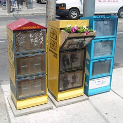 Toronto-based street artist Posterchild's latest project involves installing flower beds in the mostly run-down distribution boxes on the streets that dispense all those free publications and magazines. 