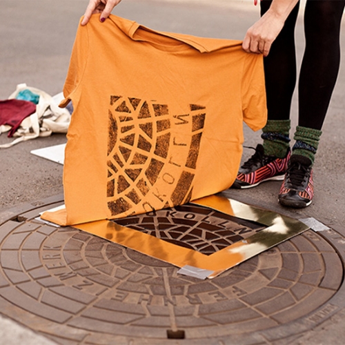 Raubdruckerin, Berlin-based collective of 'pirate printers' ink and lift images from geometric public fixtures onto shirts and totes, creating freely sourced wearable art.