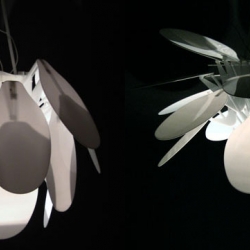 'Morphology Chandelier' is a prototype lamp by Simon Weiss.  The petals open, affecting the shape and intensity of light, in response to human presence, using an ultrasonic range finder and a linear actuator.