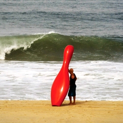 'If Slater Bowled' by Allison Wright, a pin shaped surf board (homage to pro-surfer Kelly Slater) is the main character of  the Single Pin:Red project. that seeks to bring out humor, surprise or to draw attention to unique landmarks.