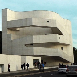 Alvaro Siza designed the new building for the Fundacion Ibere Camargo in Porto Alegre, Brazil. It opened a few weeks ago. A rectangular white concrete structure with circulations going out of its facade.