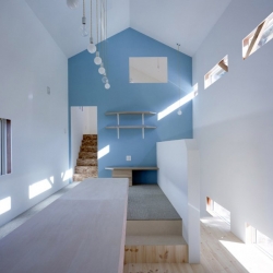 A small house in Japan whose interior volume employs traditional shapes (gables, dormers, window boxes) to create a contemporary effect.