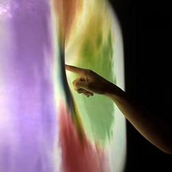 “Soak, Dye in light.” by Everyware is an interactive canvas that bleeds color when touched. Using the Kinect and custom software, the installation begs to be poked. 