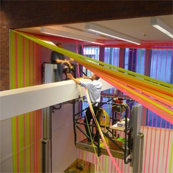 Megan Geckler's installation at the Wexner Center for the Arts , Columbus, Ohio. Called 'Spread the Ashes of the Colors' the installation is constructed from interlacing strips of flagging tape.