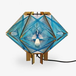 North For The Summer Andromeda Lighting Series is part sculpture and part lamp. Intricately woven string criss crosses between a wooden frame making colorful geometric patterns. 