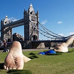 A huge installation of a man swimming on the grass on the South bank of the River Thames.  Commissioned by The Discovery Channel to promote its newest reality show, 'London Ink'.