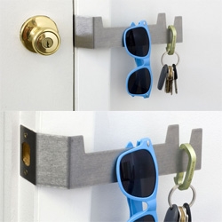 2nd Shift Studio's "Key Plate" - a redesign of a door frame strike plate, found in almost every home/office, now with a place to hang your keys/etc!