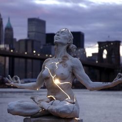 Paige Bradley created one of the most striking sculptures I've seen in recent times. Her masterpiece, entitled Expansion, is a beautiful woman seeking inner piece but fractured and bleeding with light.