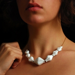 Fragile necklace by Israeli Studio Kahn is purchased in one piece. Break each link until the necklace becomes wearable.