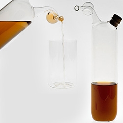 Laurence Brabant's X3cl: 1 L. "Bottle with a measuring part of 3cl. Suitable for whisky, Pastis or other alcohols. The capacity is 75cl. Also exists for one liter. Delivered with the two corks." Made of mouth-blown borosilicate glass.
