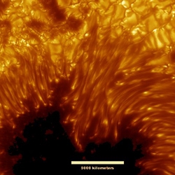 Just released, this stunning image shows remarkable and mysterious details near the dark central region of a planet-sized sunspot in one of the sharpest views ever of the surface of the Sun.