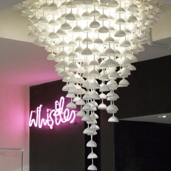 The Susurrus Chandelier is made from a collection of unglazed bone china bells by Item