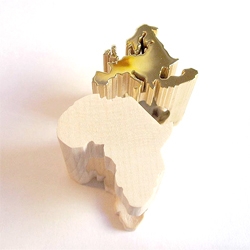 Take and Give rings by Verena Schreppel show the continents of Europe and Africa made from gold plated silver and maple wood respectively.