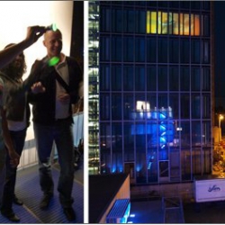 Talking Towers, Interactive Video-Installation. Participants modulate particles with a light stick, which are projected on the Kranhaus Süd in Cologne. August 16-25 at "New Talents" Design Biennale.
