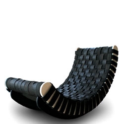 Leo Kempf has traded in cardboard pieces for FSC certified Birch & repurposed tires; 'Tired Lounge' a rocking recliner with woven reclaimed tire strips & 'Crooked Mantle' a sculptural shelf of FSC birch inlaid with tire treads.