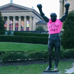 Rocky sporting a lovely art-supporting cardigan in front of the Philadelphia Museum of Art. This Saturday is the first ever International Yarn Bombing Day. 