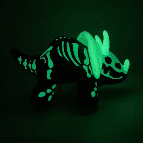 DinoGlows! Dinosaur plushies that flip inside-out to reveal glow-in-the-dark fossils. Designed by Erin McGarry, artist and founder of Womple Studios.