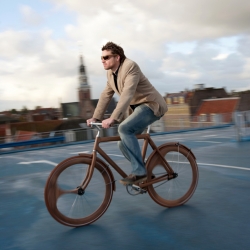 Designer Jan Gunneweg created this gorgeous wooden bicycle which not only has a solid wood frame, but asymetrical wooden wheels and natural-tone brown tires to go with. And a matching glasses..