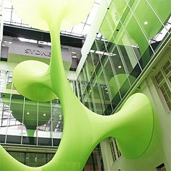A green organic temporary installation by LAVA, using hi-tech nylon.  The organic shape climbs through the atrium of the building.