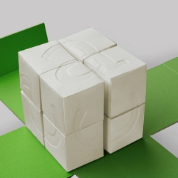 The Type-Cube made of vat paper consists of eight movable cubes, which are connected together. A fragment of a letter is engraved on each side of the cubes. Turning the cubes in different directions several combinations are offered. 