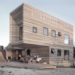 House renovation that gives an old house a  vibrant look with new wooden skin. This skin folds and generates new spaces to enjoy the home near the beach.
