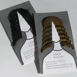 This one-color business card can be customized by inserting hairpins through the die-cut along the top of the illustration.